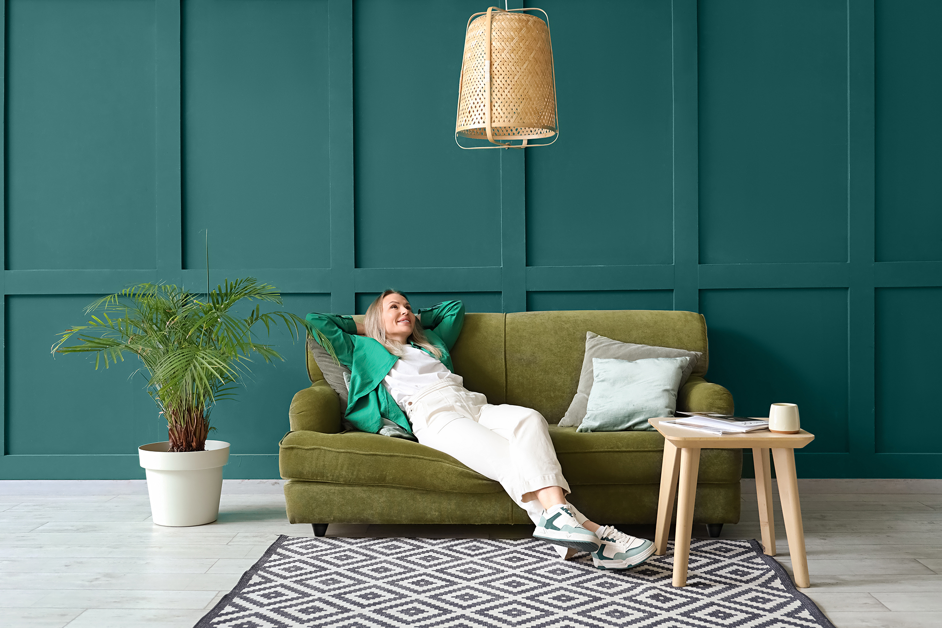 Salon biophilic design. Na zdjęciu ściana pomalowana farbą C73 Intensywny Szmaragd MAGNAT Ceramic.